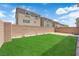 Backyard with artificial grass, potted plants, and privacy wall at 5616 Canoe Ridge Ct, Las Vegas, NV 89141