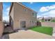 A fully fenced backyard features a patio and green synthetic lawn for easy care and enjoyment at 5616 Canoe Ridge Ct, Las Vegas, NV 89141