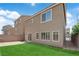 Landscaped backyard with artificial grass area, patio, and barbecue at 5616 Canoe Ridge Ct, Las Vegas, NV 89141