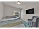 Comfortable bedroom with a plush armchair and ample natural light at 5616 Canoe Ridge Ct, Las Vegas, NV 89141