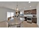 Elegant kitchen with stainless steel appliances, granite countertops, and a large island with seating at 5616 Canoe Ridge Ct, Las Vegas, NV 89141
