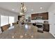 Bright kitchen with a large island, stainless steel appliances, and dark wood cabinetry at 5616 Canoe Ridge Ct, Las Vegas, NV 89141