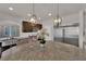 Modern kitchen featuring granite countertops, stainless steel appliances, and stylish pendant lighting at 5616 Canoe Ridge Ct, Las Vegas, NV 89141