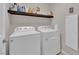 Practical laundry room with side-by-side washer and dryer, and shelf at 5616 Canoe Ridge Ct, Las Vegas, NV 89141