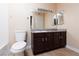 Bathroom featuring a dark wood vanity, tiled floor, and large mirror at 6800 E Lake Mead Blvd # 2076, Las Vegas, NV 89156