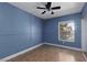 A cozy bedroom features tile flooring, blue walls, and a ceiling fan at 6800 E Lake Mead Blvd # 2076, Las Vegas, NV 89156
