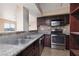 A kitchen features stainless steel appliances, tile backsplash, and granite countertops at 6800 E Lake Mead Blvd # 2076, Las Vegas, NV 89156