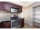A kitchen features stainless steel appliances, dark cabinets, and tile backsplash at 6800 E Lake Mead Blvd # 2076, Las Vegas, NV 89156