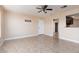 Neutral living room featuring a ceiling fan, tiled floors, and access to other rooms at 6800 E Lake Mead Blvd # 2076, Las Vegas, NV 89156
