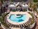 Aerial shot of a community pool surrounded by lounge chairs and palm trees in a desert landscape at 6800 E Lake Mead Blvd # 2076, Las Vegas, NV 89156