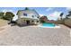 Inviting backyard featuring a refreshing swimming pool, rock landscaping, and ample open space at 6999 Montcliff Ave, Las Vegas, NV 89147