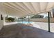 A covered patio area with view of the backyard oasis that features a refreshing swimming pool at 6999 Montcliff Ave, Las Vegas, NV 89147