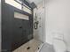 Contemporary bathroom featuring walk-in shower with glass door, custom tile, and modern fixtures at 6999 Montcliff Ave, Las Vegas, NV 89147