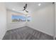 A bright bedroom with large windows, and soft grey carpet at 6999 Montcliff Ave, Las Vegas, NV 89147