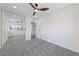 A bright bedroom with closet doors, ceiling fan, and soft grey carpet at 6999 Montcliff Ave, Las Vegas, NV 89147