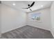 A bright bedroom with a large window, ceiling fan, and soft grey carpet at 6999 Montcliff Ave, Las Vegas, NV 89147