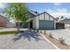 Charming two-story home with a lush tree in the front yard and a well-maintained lawn at 6999 Montcliff Ave, Las Vegas, NV 89147