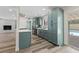 Updated kitchen features stainless steel appliances, teal cabinets, white countertops, and backyard views at 6999 Montcliff Ave, Las Vegas, NV 89147