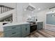 Well-appointed kitchen with stainless steel oven, stone countertops, and views to the fireplace at 6999 Montcliff Ave, Las Vegas, NV 89147