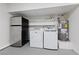 A laundry room with washer, dryer, refrigerator, water heater and shelving at 6999 Montcliff Ave, Las Vegas, NV 89147