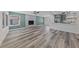 An open-concept living area features modern flooring, an elegant fireplace, and an open view to the kitchen at 6999 Montcliff Ave, Las Vegas, NV 89147