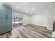 Bright living room features recessed lighting, wood floors, and sliding glass door to backyard at 6999 Montcliff Ave, Las Vegas, NV 89147