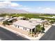 Lovely aerial view of the home situated among landscaped yards, nearby orchard and mountain backdrop at 7230 Fresh Harvest Ave, Las Vegas, NV 89131