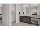 Bathroom with granite countertop vanity, dual mirrors, and a private toilet area at 7230 Fresh Harvest Ave, Las Vegas, NV 89131