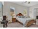 Cozy bedroom with two sunny windows, wooden furniture, and carpet at 7230 Fresh Harvest Ave, Las Vegas, NV 89131