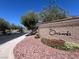 Community entrance sign surrounded by a rock bed and well-maintained landscaping at 7230 Fresh Harvest Ave, Las Vegas, NV 89131
