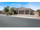 A stunning single-story home featuring a three-car garage and stone pillar accents at 7230 Fresh Harvest Ave, Las Vegas, NV 89131