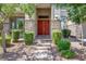 Charming front entrance with stone accents, red double doors, and landscaped garden at 7230 Fresh Harvest Ave, Las Vegas, NV 89131