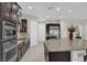 Modern kitchen featuring stainless steel appliances and a large center island with granite countertops at 7230 Fresh Harvest Ave, Las Vegas, NV 89131