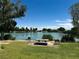 Scenic lake view with picnic tables and lush greenery for relaxing outdoors at 7230 Fresh Harvest Ave, Las Vegas, NV 89131