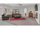 Spacious living room with carpet, fireplace, and large window overlooking the backyard at 7230 Fresh Harvest Ave, Las Vegas, NV 89131