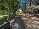 Scenic park path with picnic tables and trees, providing a natural space for outdoor activities and relaxation at 7230 Fresh Harvest Ave, Las Vegas, NV 89131