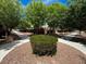Landscaped common area with sidewalks and mature trees creating a park-like setting at 7230 Fresh Harvest Ave, Las Vegas, NV 89131