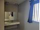 A bedroom area features a built-in vanity and an expansive mirror at 745 Greenbriar Townhouse Way, Las Vegas, NV 89121