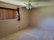 Neutral bedroom with ceiling fan and carpet at 745 Greenbriar Townhouse Way, Las Vegas, NV 89121