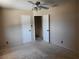 Bedroom featuring neutral walls, ceiling fan and carpet at 745 Greenbriar Townhouse Way, Las Vegas, NV 89121
