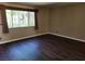 An empty bedroom features vinyl flooring and a window at 745 Greenbriar Townhouse Way, Las Vegas, NV 89121
