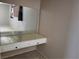 A bedroom area features a built-in vanity and an expansive mirror at 745 Greenbriar Townhouse Way, Las Vegas, NV 89121