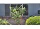 Exterior view featuring a shrubbery in front of a window at 745 Greenbriar Townhouse Way, Las Vegas, NV 89121