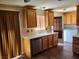 A well lit kitchen with a view to the laundry room at 745 Greenbriar Townhouse Way, Las Vegas, NV 89121
