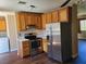 Open concept kitchen featuring stainless steel appliances and wood cabinets at 745 Greenbriar Townhouse Way, Las Vegas, NV 89121
