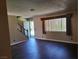 Well-lit living room with new floors and staircase at 745 Greenbriar Townhouse Way, Las Vegas, NV 89121