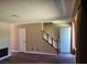 Spacious living room with staircase, modern flooring, and neutral paint at 745 Greenbriar Townhouse Way, Las Vegas, NV 89121