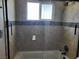 Bathroom tile shower with glass doors and small window at 745 Greenbriar Townhouse Way, Las Vegas, NV 89121
