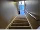 A carpeted staircase with wooden railing ascends to the next level at 745 Greenbriar Townhouse Way, Las Vegas, NV 89121