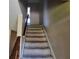 A carpeted staircase with wooden railing ascends to the next level at 745 Greenbriar Townhouse Way, Las Vegas, NV 89121